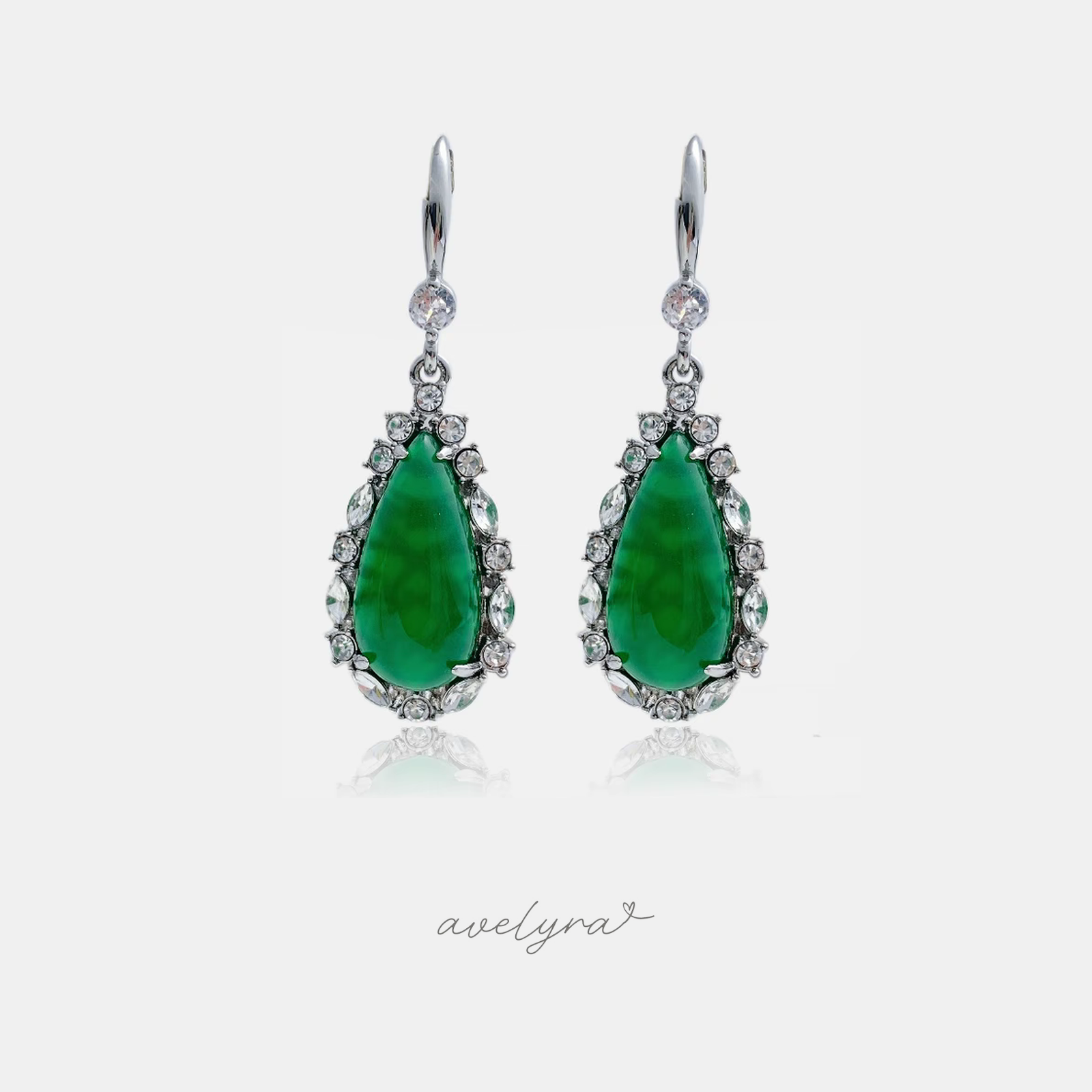 Silver-tone lever-back drop earrings with green teardrop cabochon and clear crystal halo.