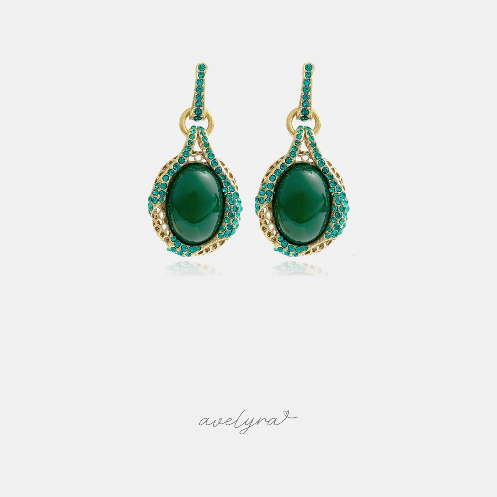 Gold-tone drop earrings with green oval cabochon framed by teal crystals and a pave bar top.