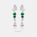 Silver-tone drop earrings with clear pear crystals, green cabochon beads and a clear teardrop crystal.