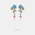 Silver-tone floral drop earrings with turquoise petals, pink centre, green leaves and pink teardrop crystal.