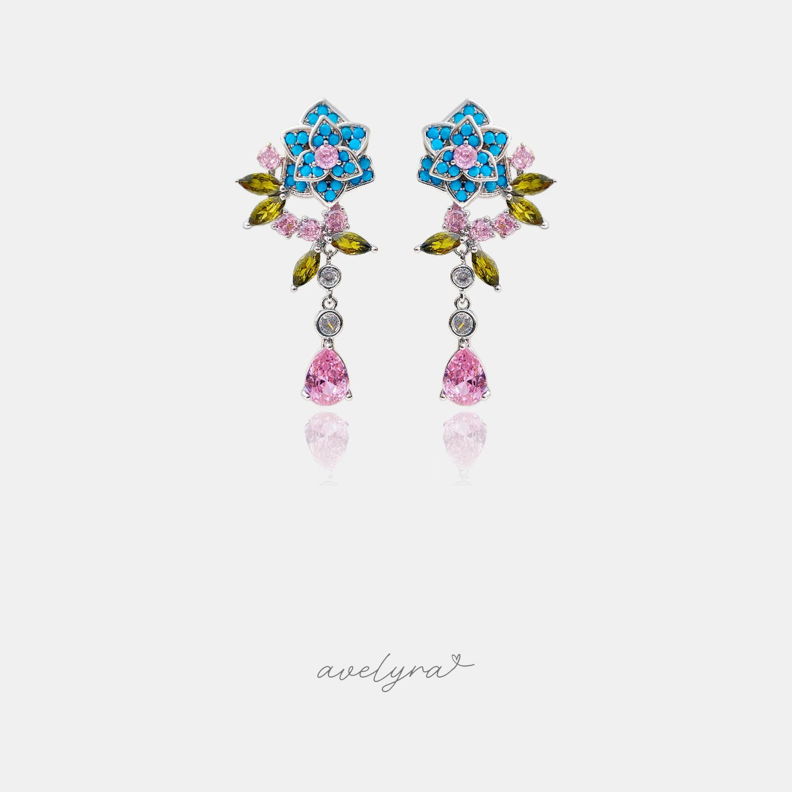 Silver-tone floral drop earrings with turquoise petals, pink centre, green leaves and pink teardrop crystal.