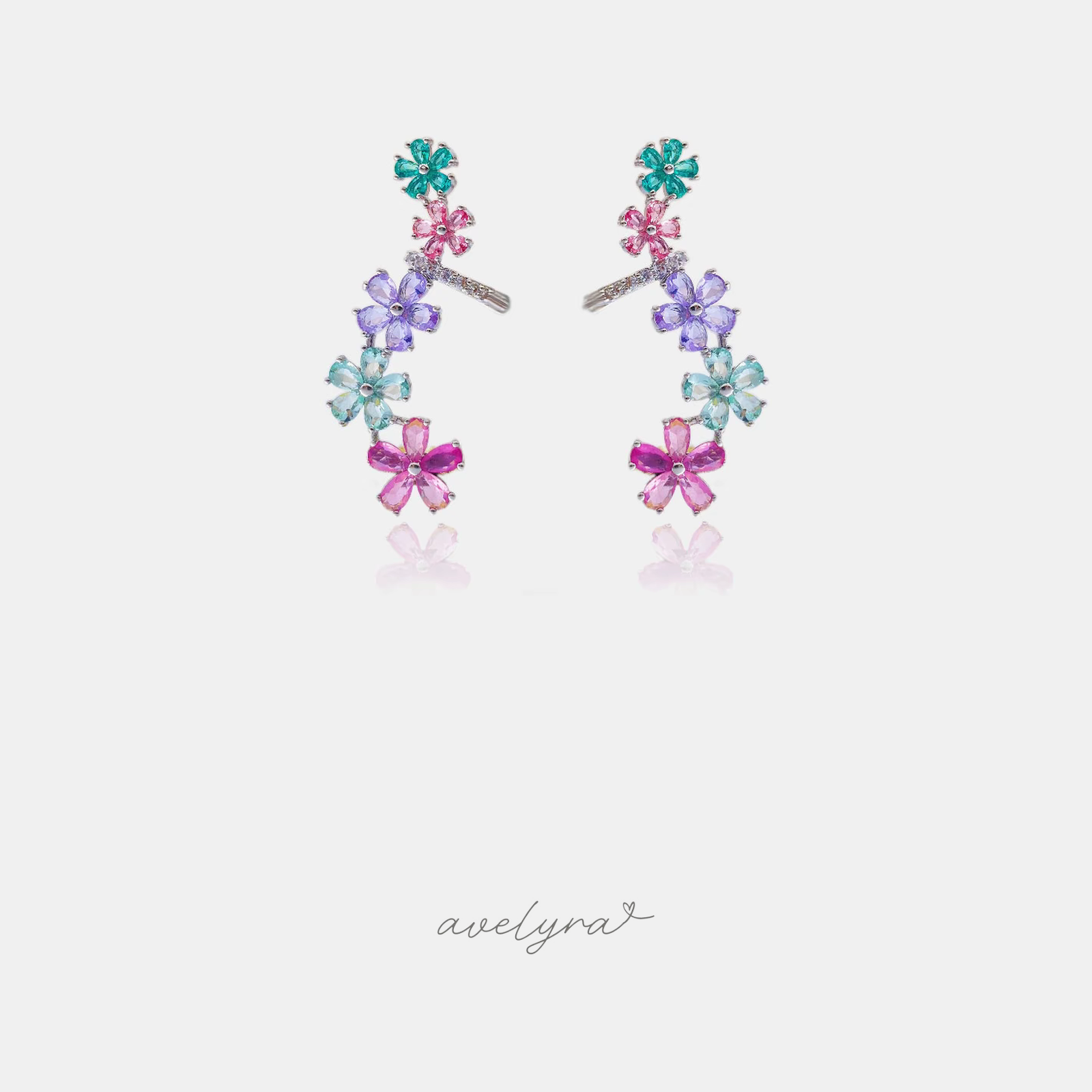 Silver-tone climbing earrings with green, pink, purple and blue crystal flowers.