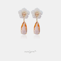White carved flower stud earrings with a faceted peach teardrop drop.
