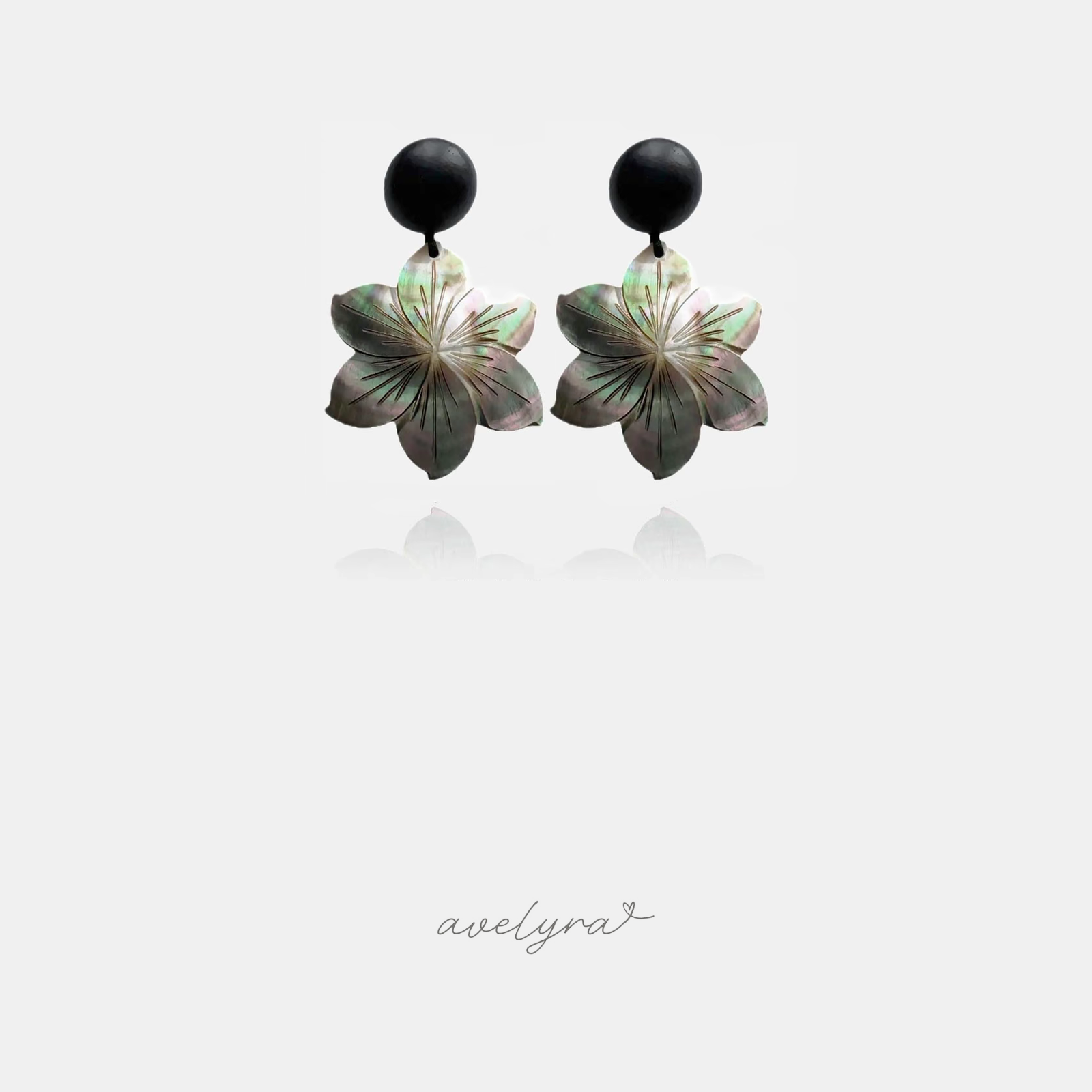Black round stud earrings with carved iridescent shell flower drops.