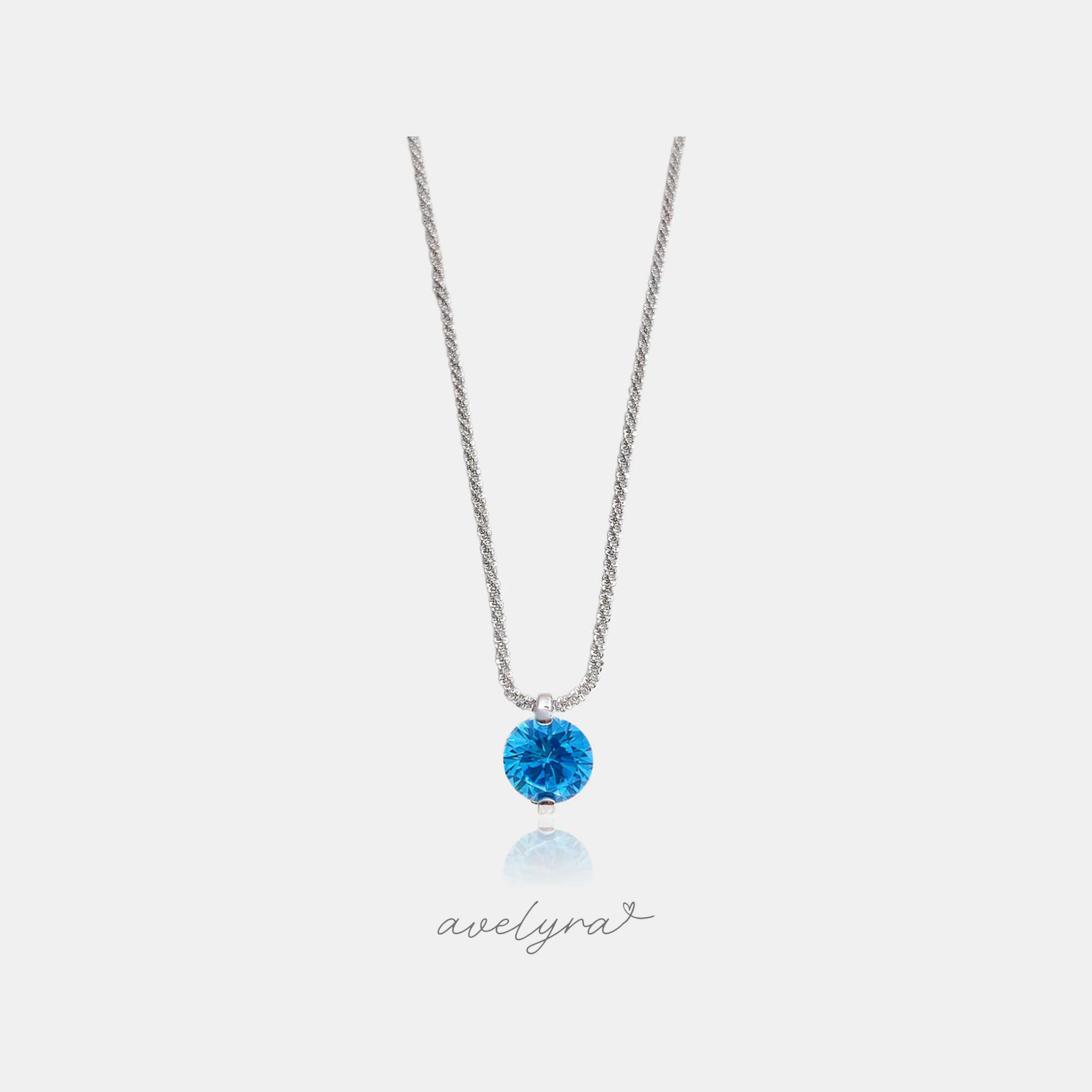 Silvery sparkle rope chain with a single round blue stone pendant.