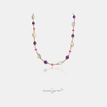 Golden chain necklace with violet round beads, white baroque pearls and pink accent beads.