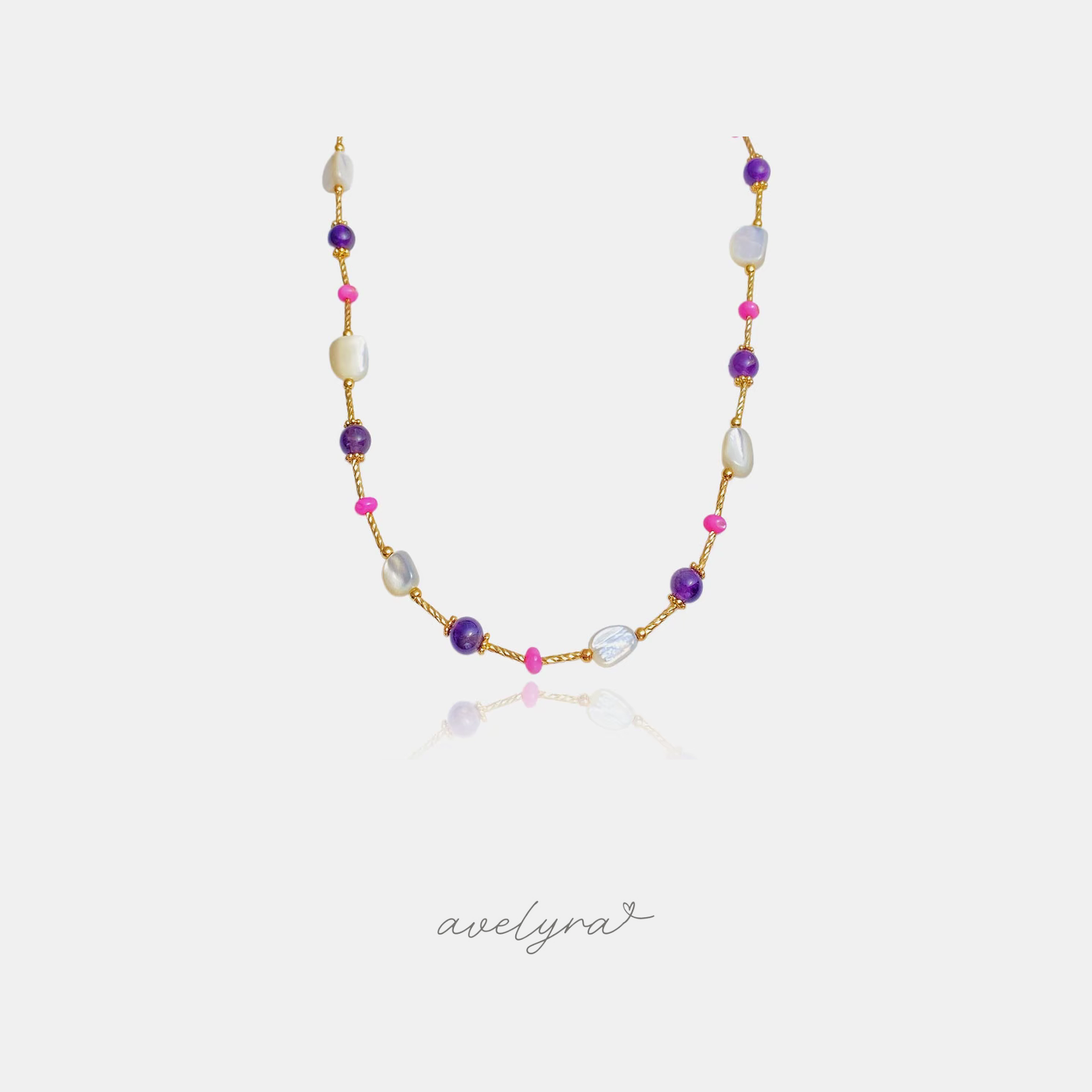 Golden chain necklace with violet round beads, white baroque pearls and pink accent beads.