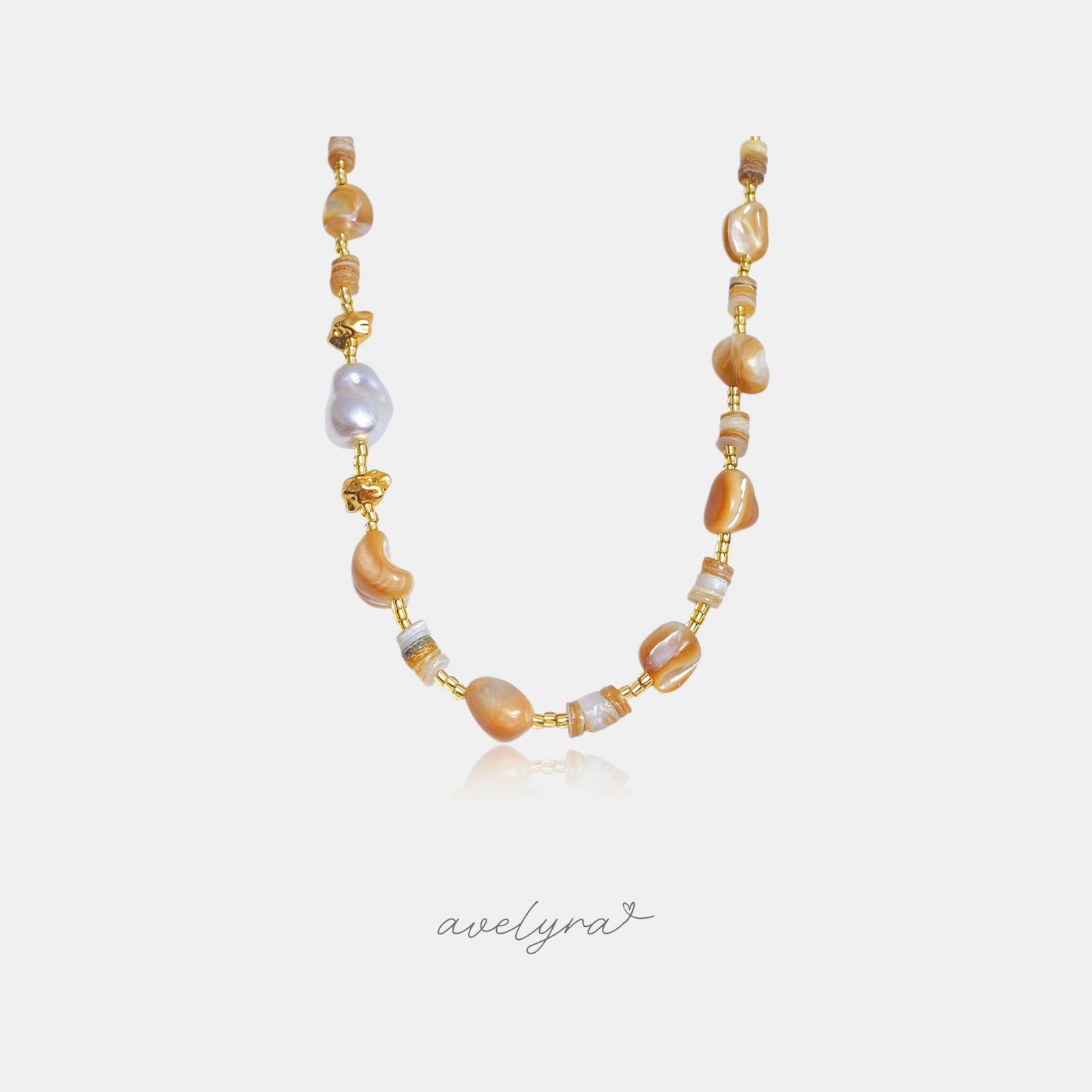 Beaded necklace with caramel stone beads, shell discs, grey baroque pearl and gold accents.