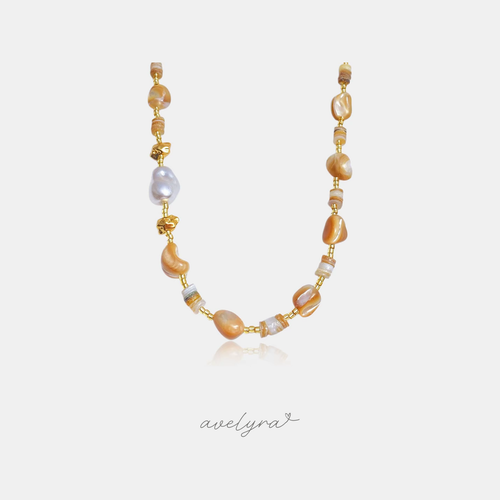 Beaded necklace with caramel stone beads, shell discs, grey baroque pearl and gold accents.