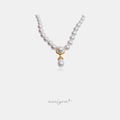 Round pearl strand with a gold pave crescent and a teardrop pearl drop pendant.