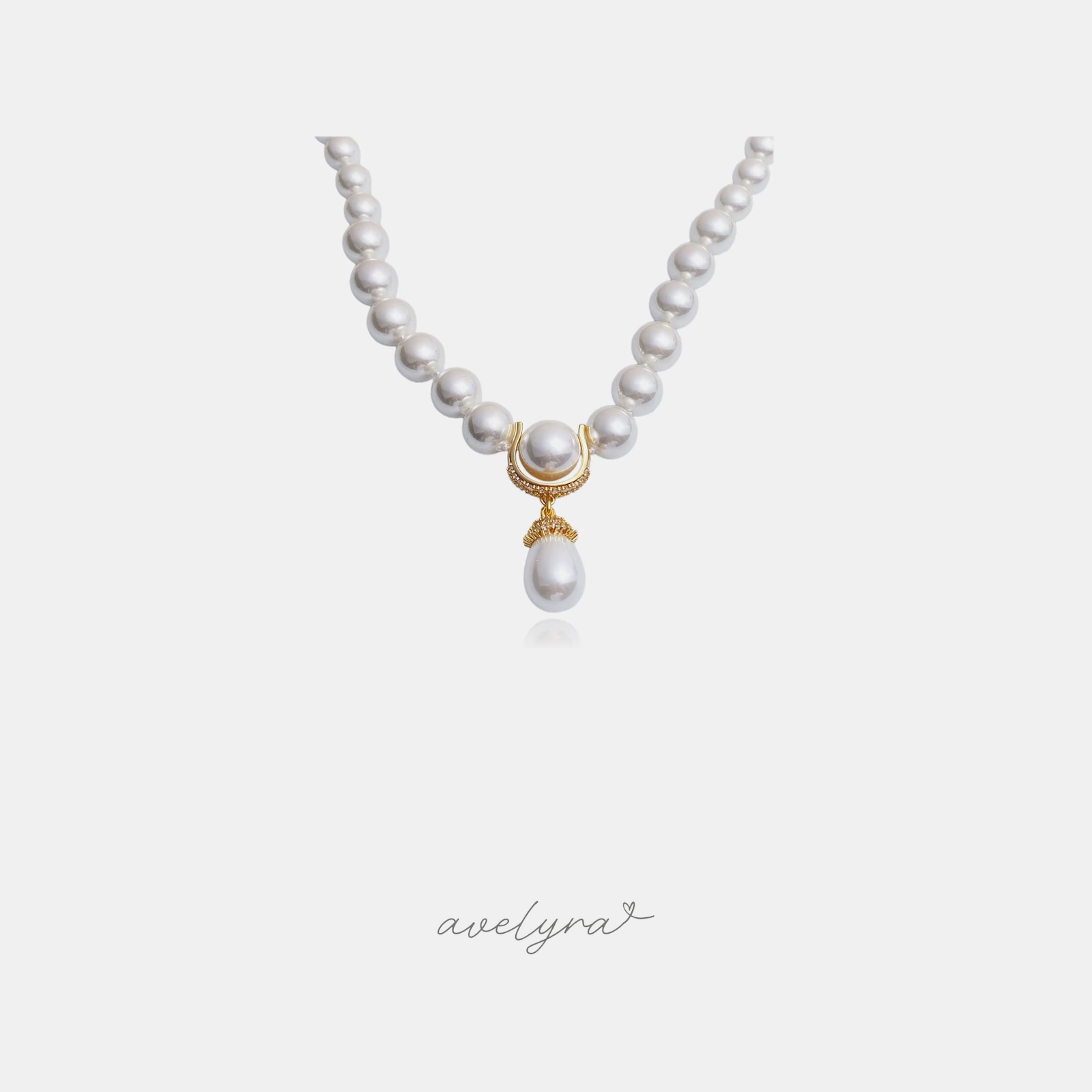 Round pearl strand with a gold pave crescent and a teardrop pearl drop pendant.