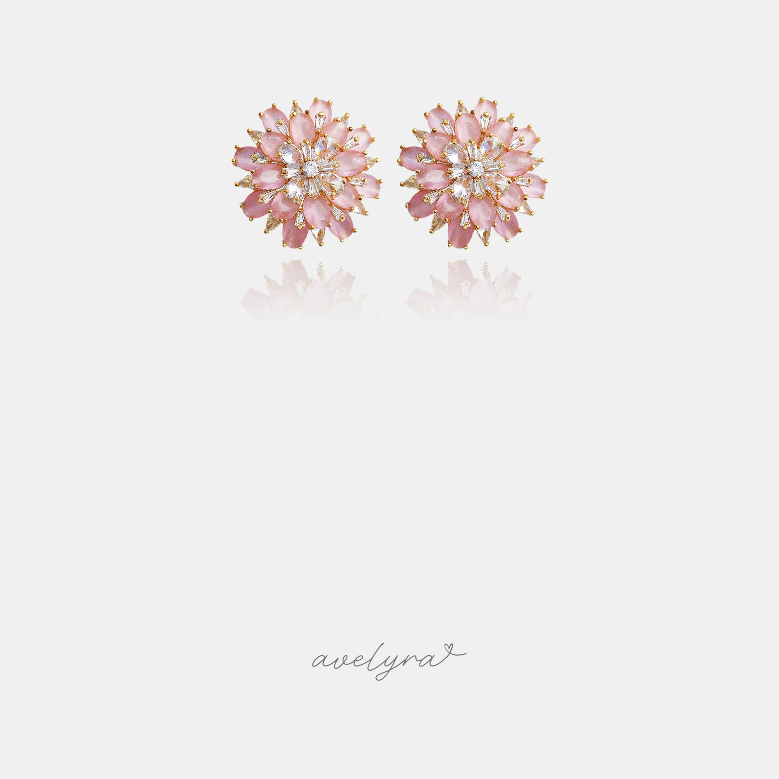 Round floral cluster stud earrings with pink petal-shaped stones and clear crystals around a central stone.