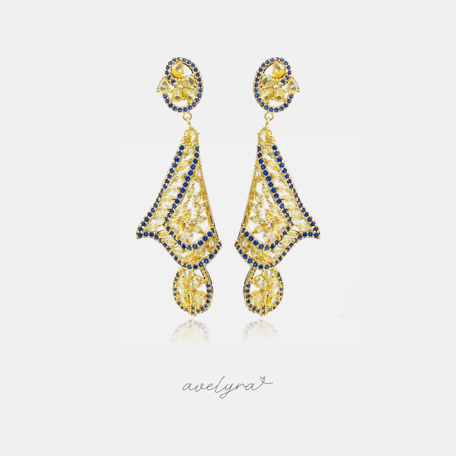 Gold-tone chandelier earrings with yellow stones outlined by rows of blue stones.