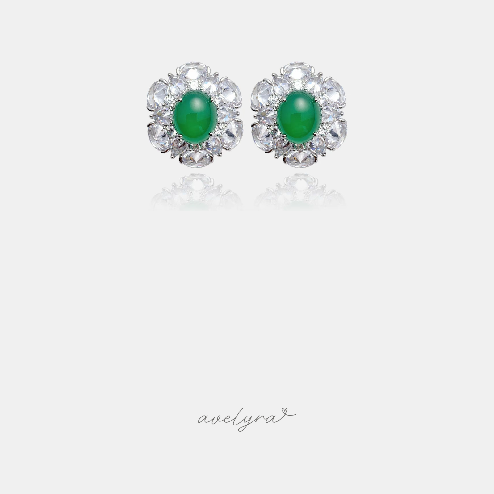 Pair of silver-tone flower stud earrings with a green oval centre stone surrounded by clear faceted petal stones.