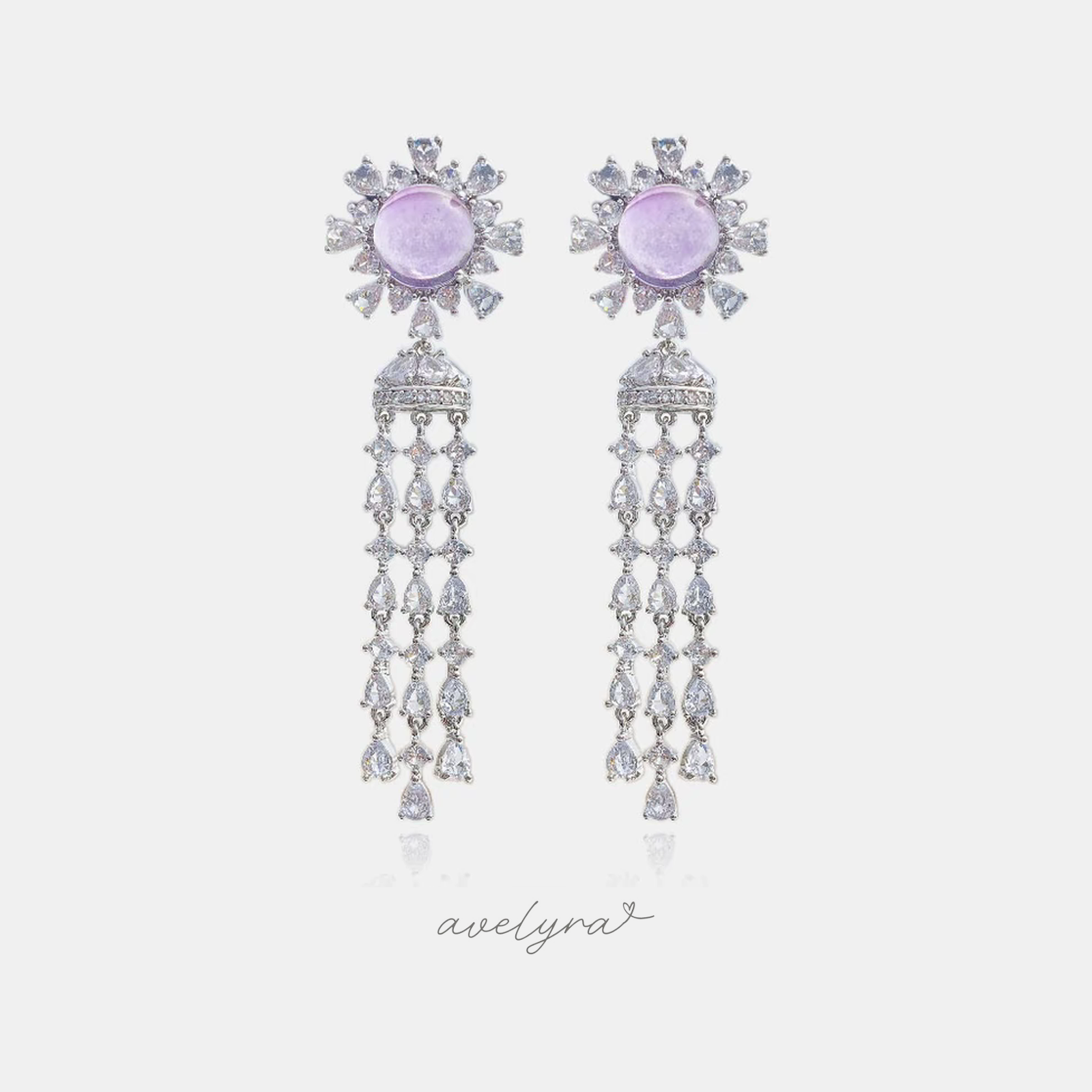 Silver-tone chandelier earrings with lilac round cabochon, crystal halo and cascading teardrop crystal strands.