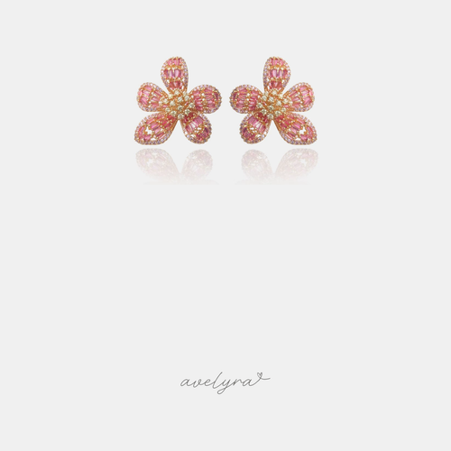 Gold-tone flower stud earrings with pink baguette stone petals and a crystal centre.