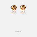 Small stud earrings each set with a single round faceted amber-gold crystal.