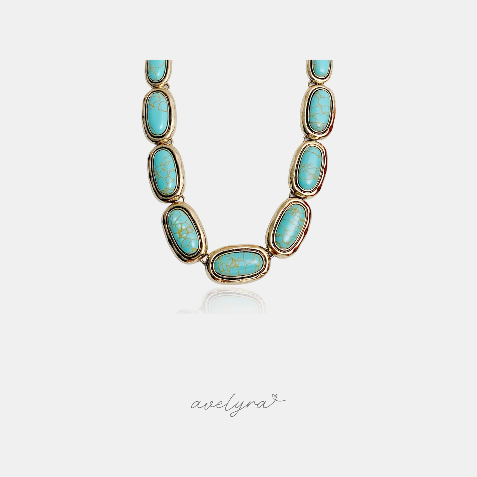 Statement necklace of oval turquoise-toned veined stones set in gold bezels linked together.